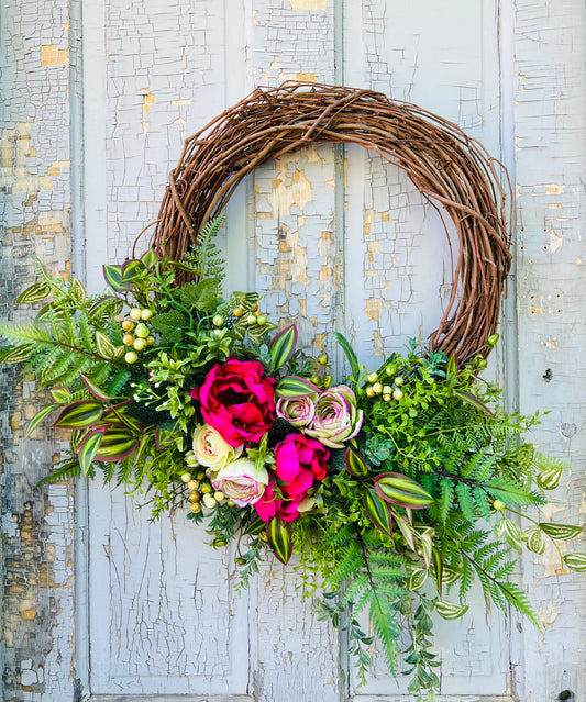 Summer Breeze floral wreath featuring vibrant peonies, ranunculus, and mixed greenery with asymmetrical garden design by Gardenbug Designs