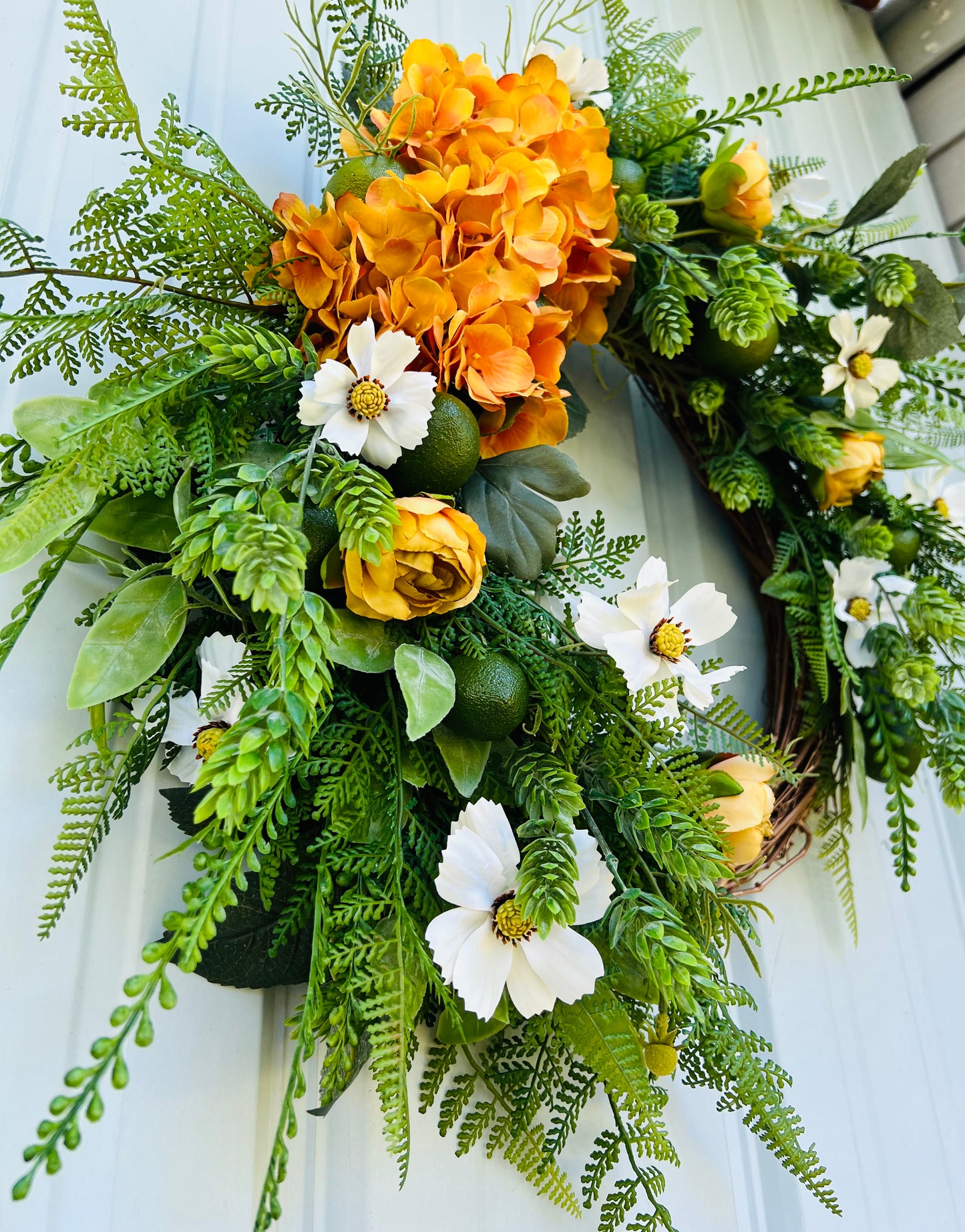 Angled depth view of Moscow Mule wreath focusing on layered greenery, citrus accents, and dimensional botanical placement