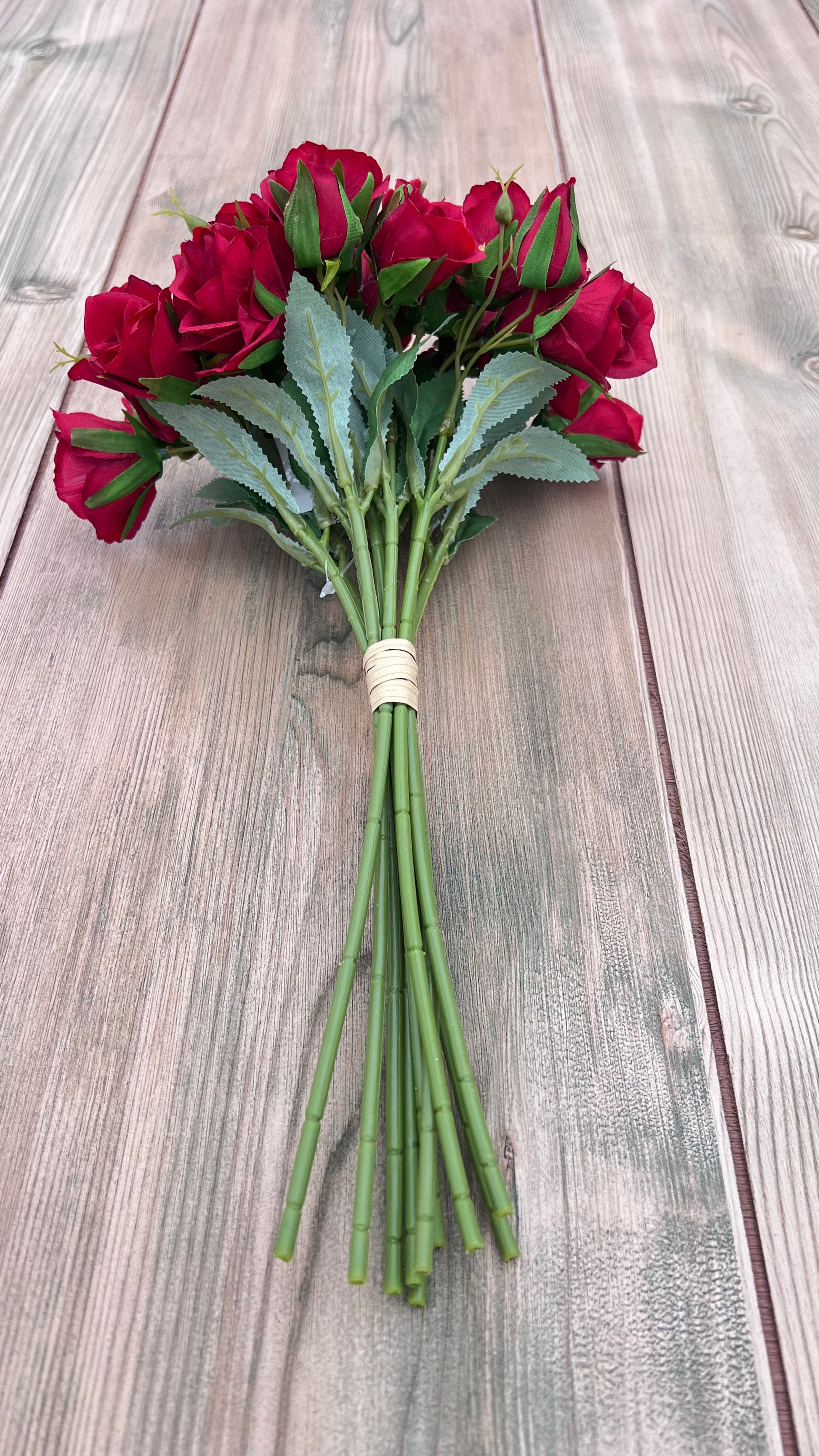 Red Rose Bundle showing full floral bundle construction with multiple rose blooms and greenery accents