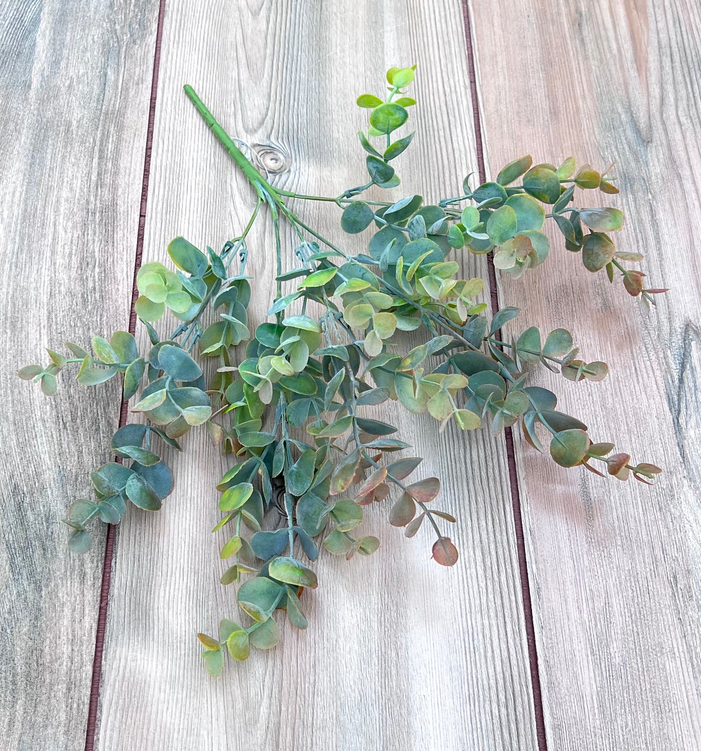 Bronze Tips faux eucalyptus greenery bush displayed from an alternate angle showing fullness and movement
