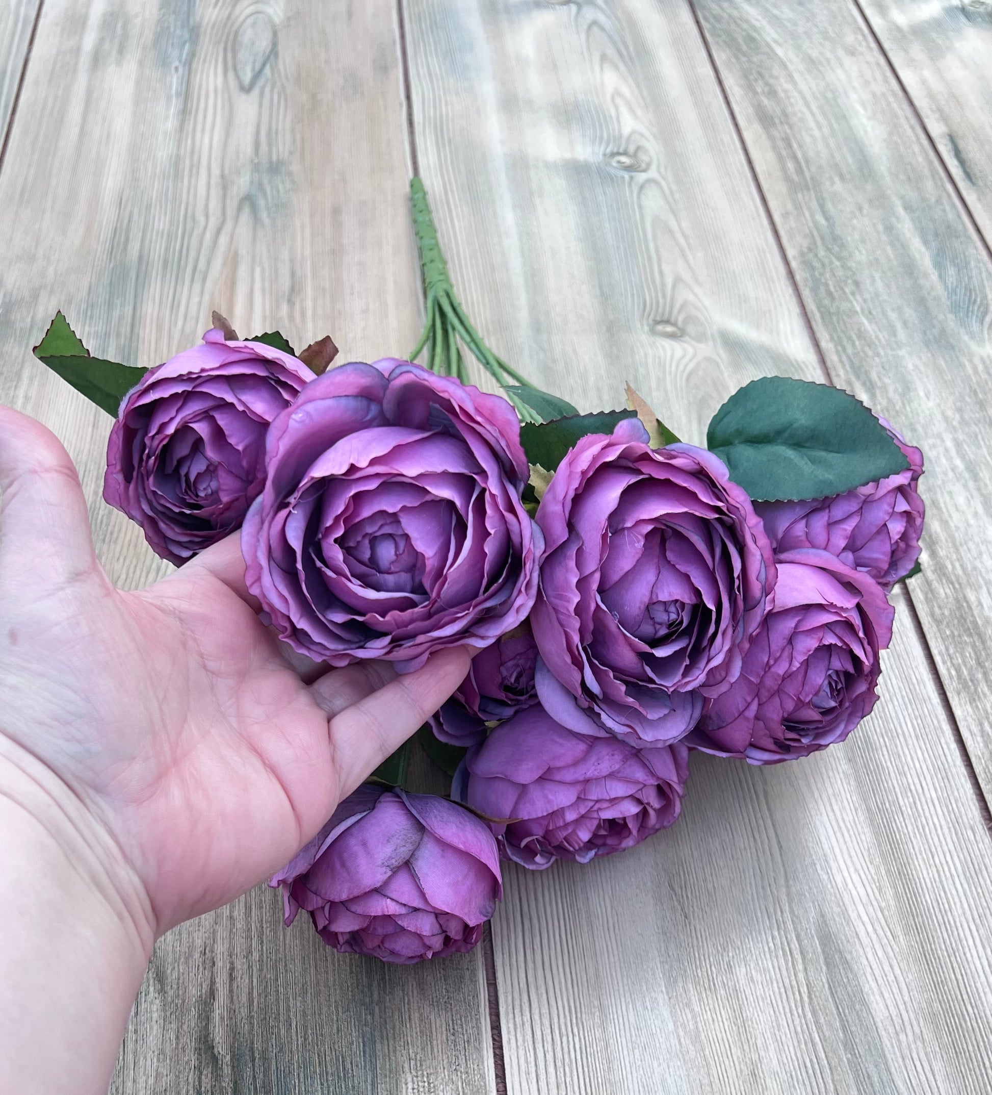 Artificial Antique Violet cabbage rose bush shown with hand for size and scale reference