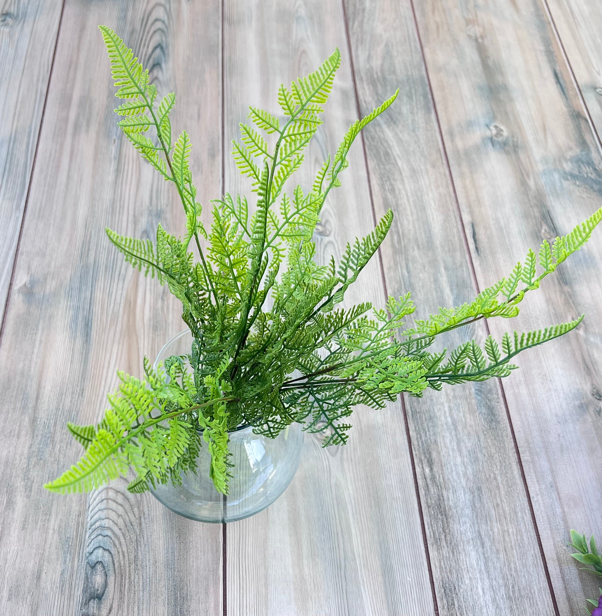 Leather Leaf Fern faux greenery bundle photographed in a glass vase from an alternate angle highlighting layered construction.
