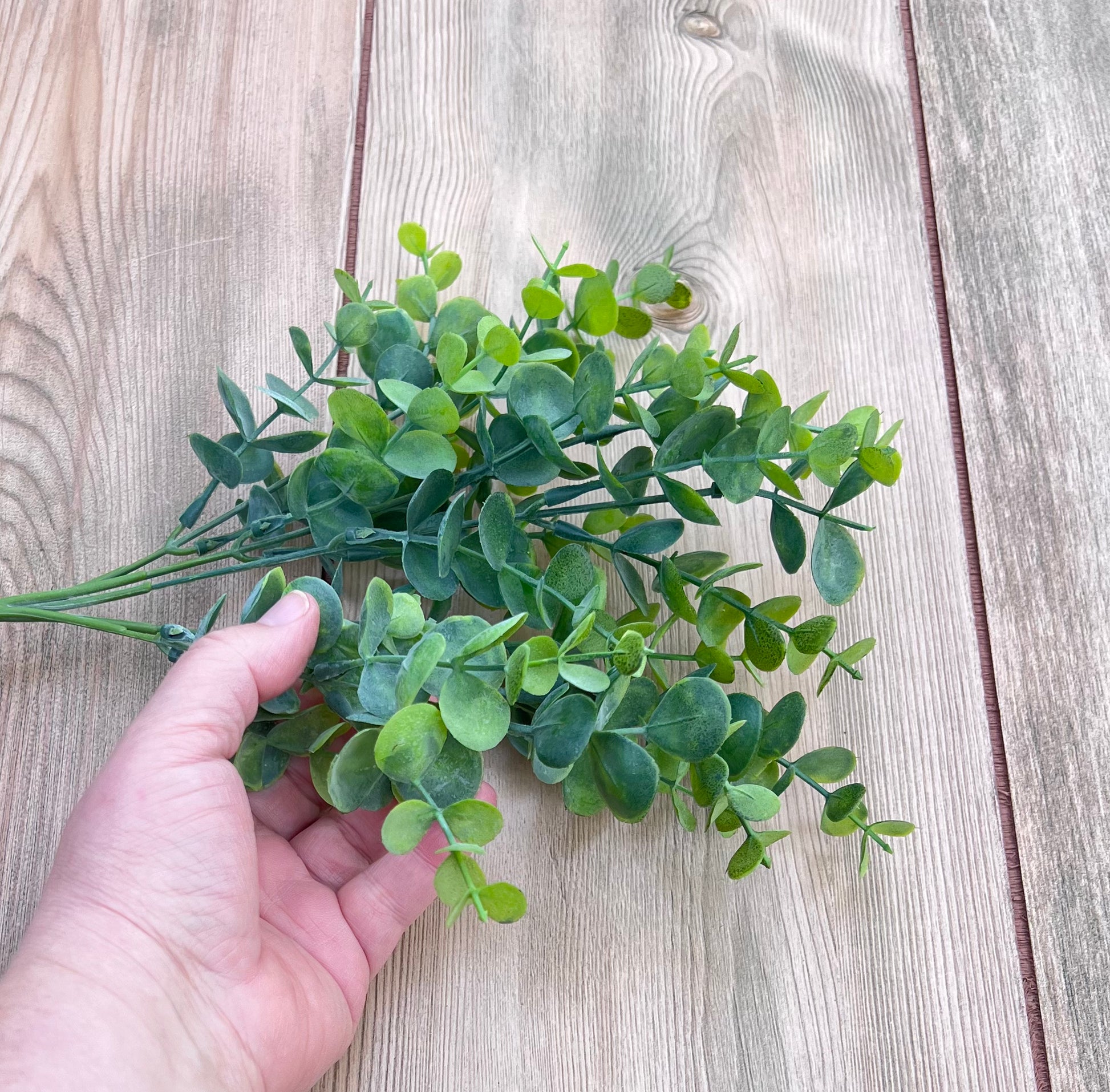 Our faux Eucalyptus Bush | Spring Green shown in hand for scale and size reference