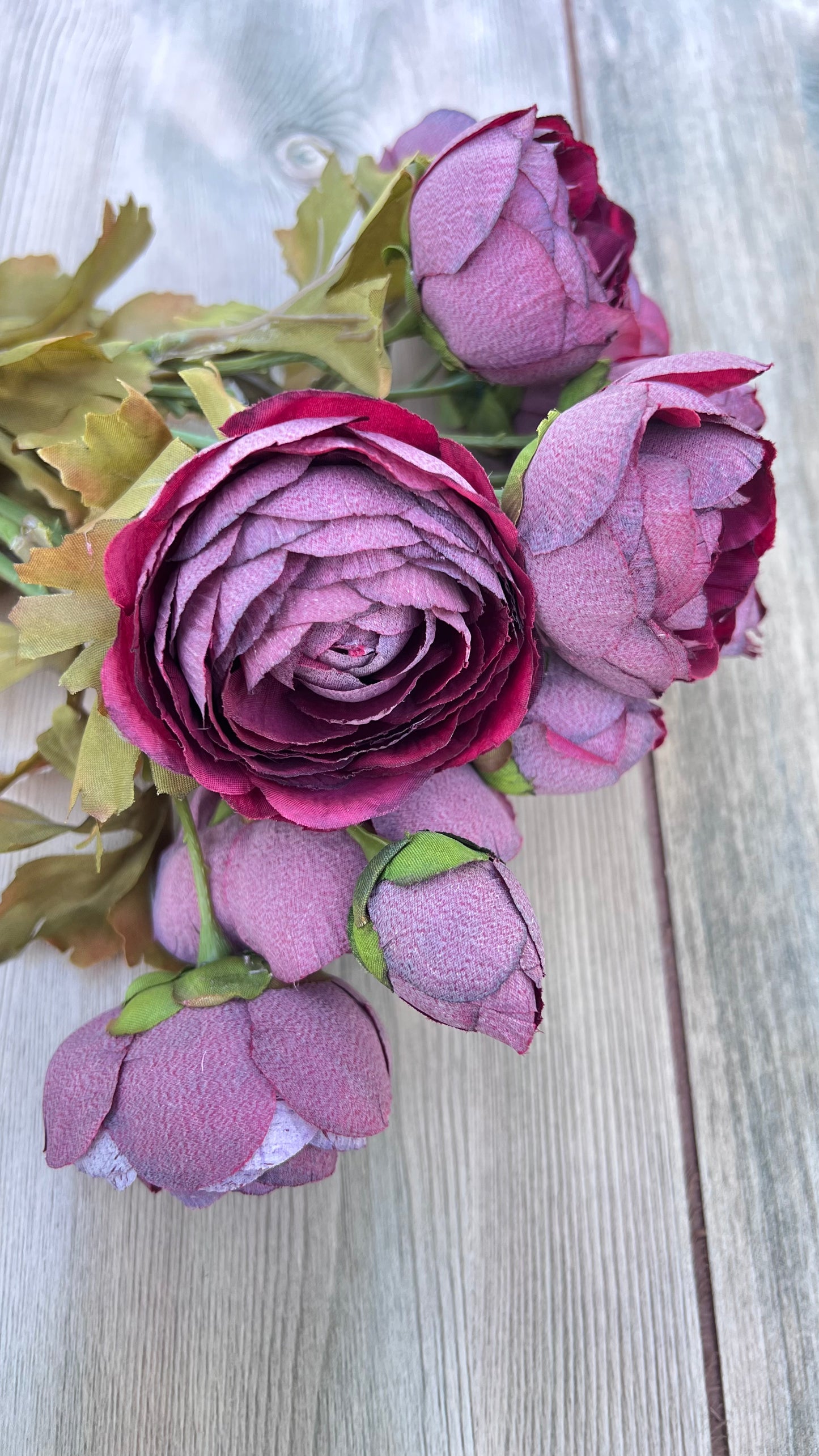 Botanical detail of the faux Burgundy Ranunculus Bundle highlighting layered petals, multiple bloom stages, and realistic foliage.