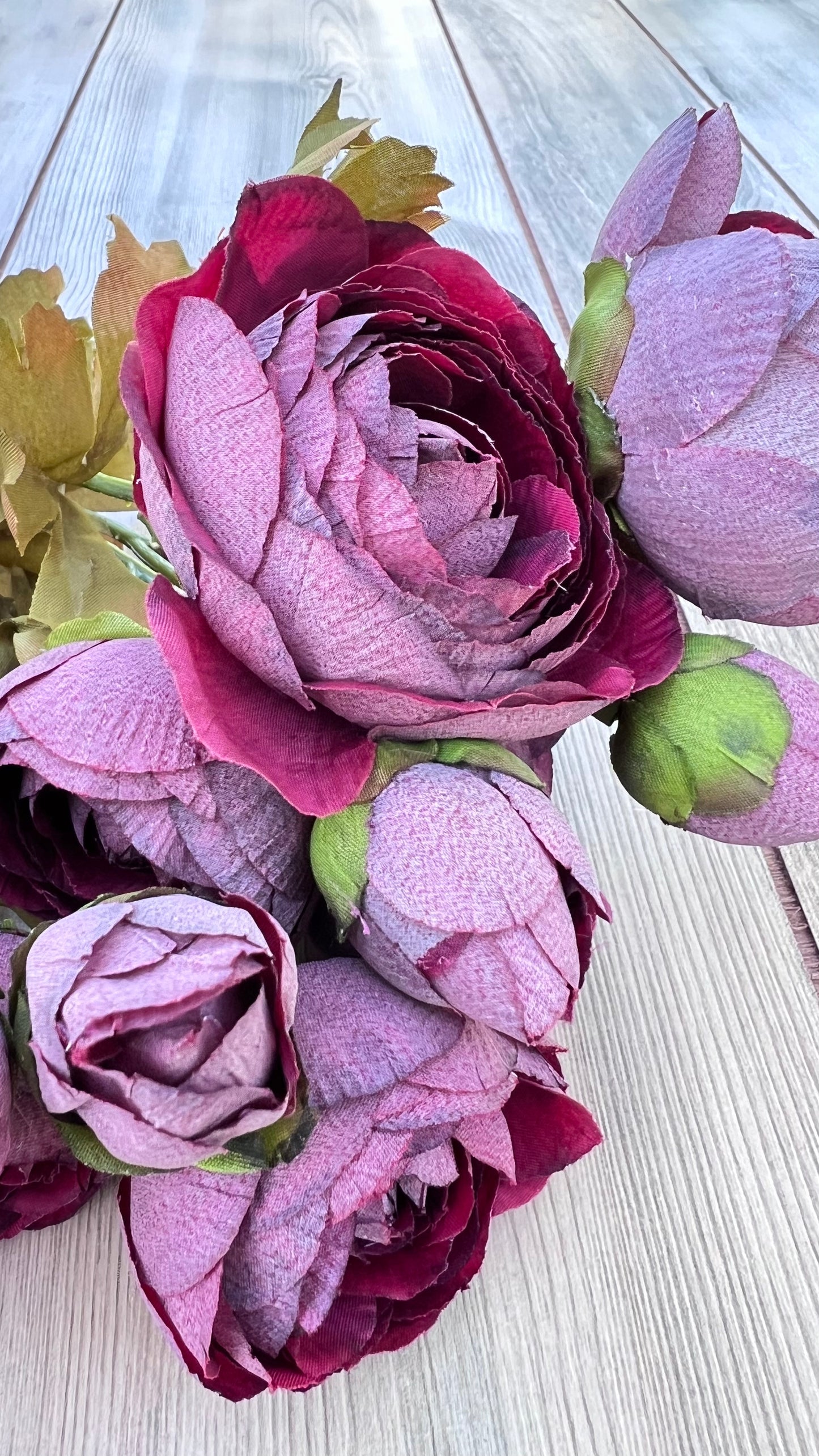 Texture detail of the Burgundy Ranunculus Bundle showcasing layered fabric petals, realistic color variation, and lifelike bloom construction.