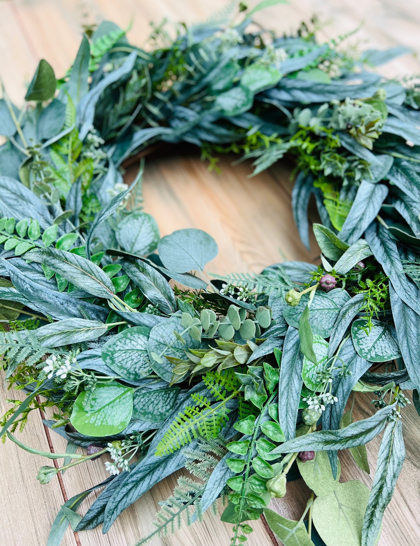 Hartley botanical greenery wreath shown in a flat lay view highlighting interior opening depth, layered foliage structure, and realistic botanical details | Gardenbug Designs