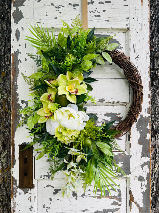 Handcrafted Margarita Botanical wreath with orchids, peonies, hydrangea, greenery, and lime accents for spring and summer front door decor by Gardenbug Designs.