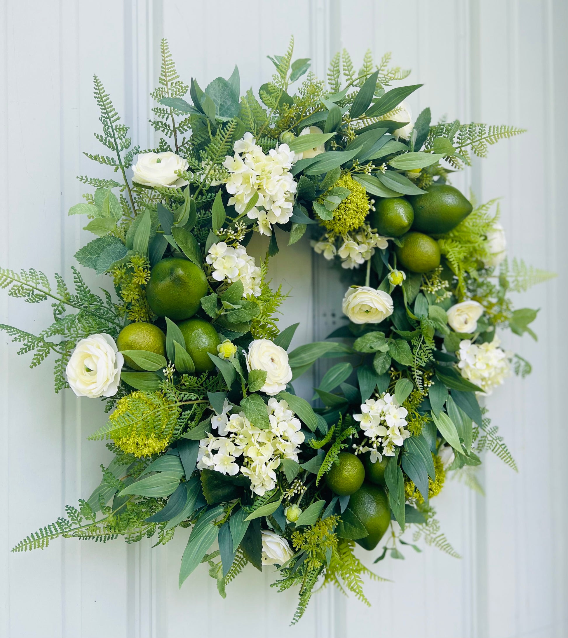 Mojito botanical wreath angled view showcasing layered greenery, natural movement, and balanced design structure | Gardenbug Designs 