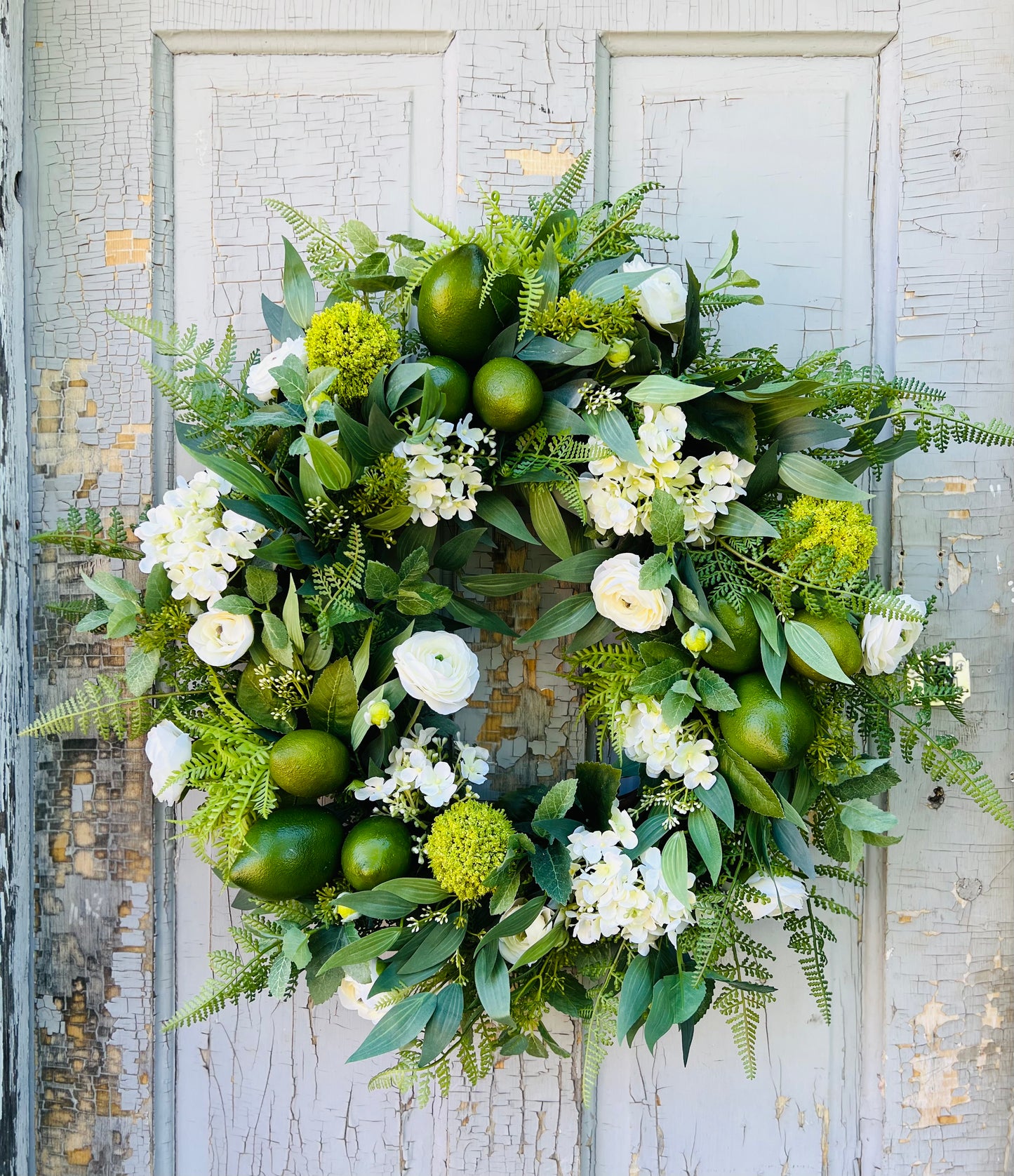 Mojito botanical wreath design from the Frankie Jean's collection styled on a gray door showing full composition | Gardenbug Designs