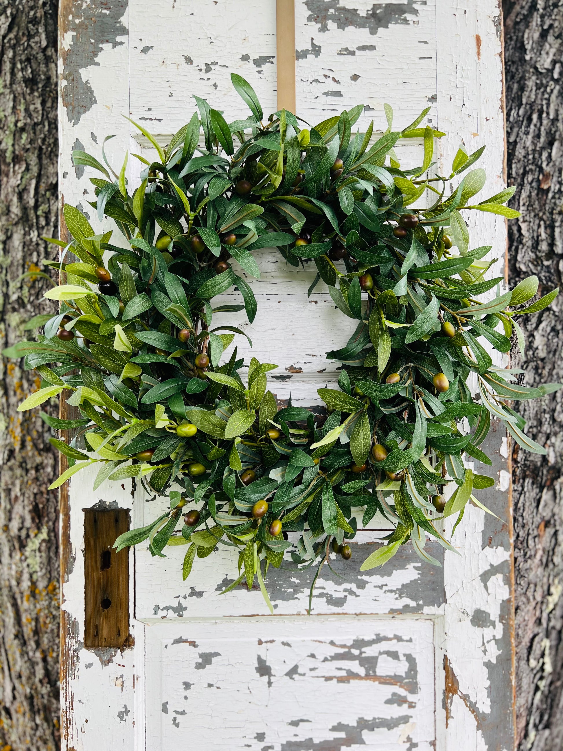 Olive Grove Botanical Wreath with realistic olive branches and fruit on a grapevine base for year-round entryway styling by Gardenbug Designs.