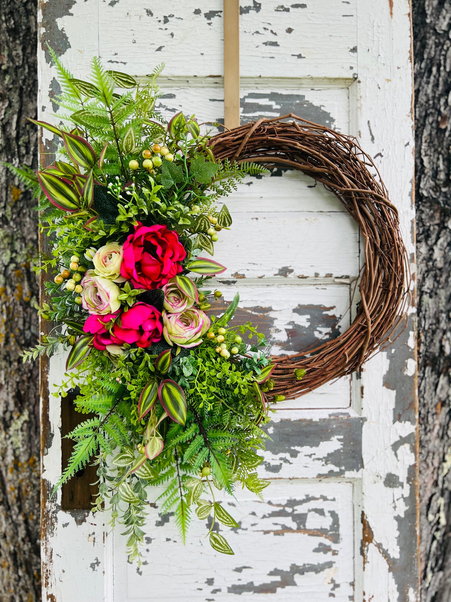 Summer Breeze floral wreath with fuchsia peonies, ranunculus, and greenery for summer front door decor designed by Gardenbug Designs.