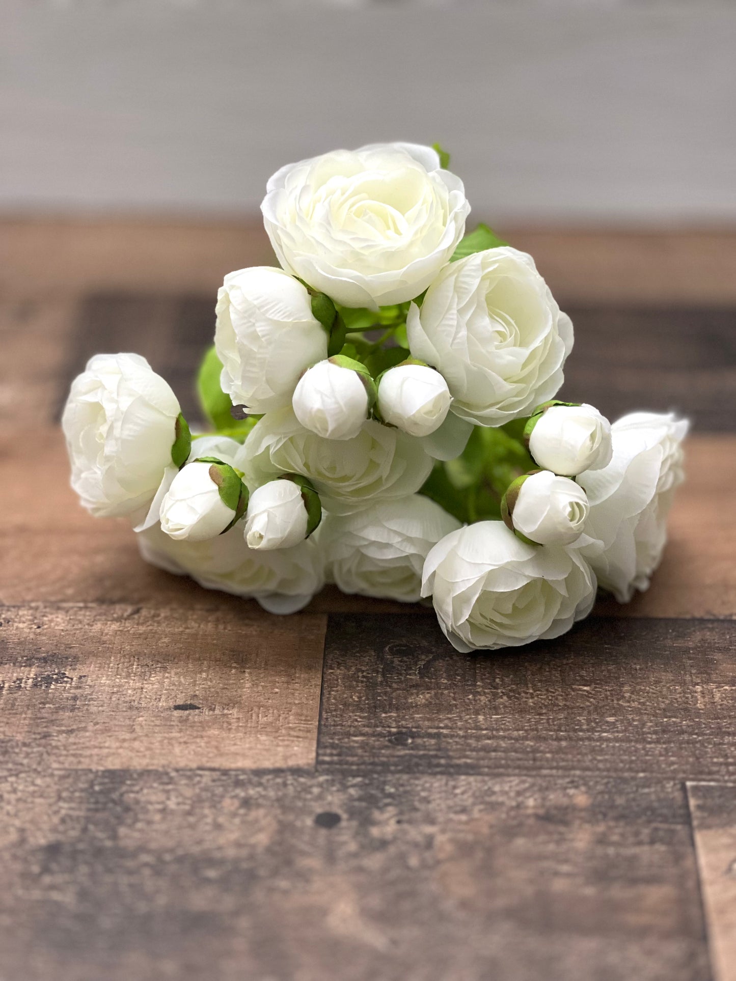 White ranunculus bundle shown in a full front-facing view, highlighting bloom shape and natural variation