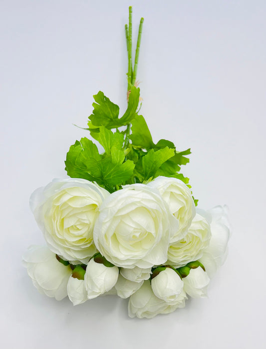 Top-down view of white ranunculus bundle showing bloom placement, bud detail, and bundled stem orientation