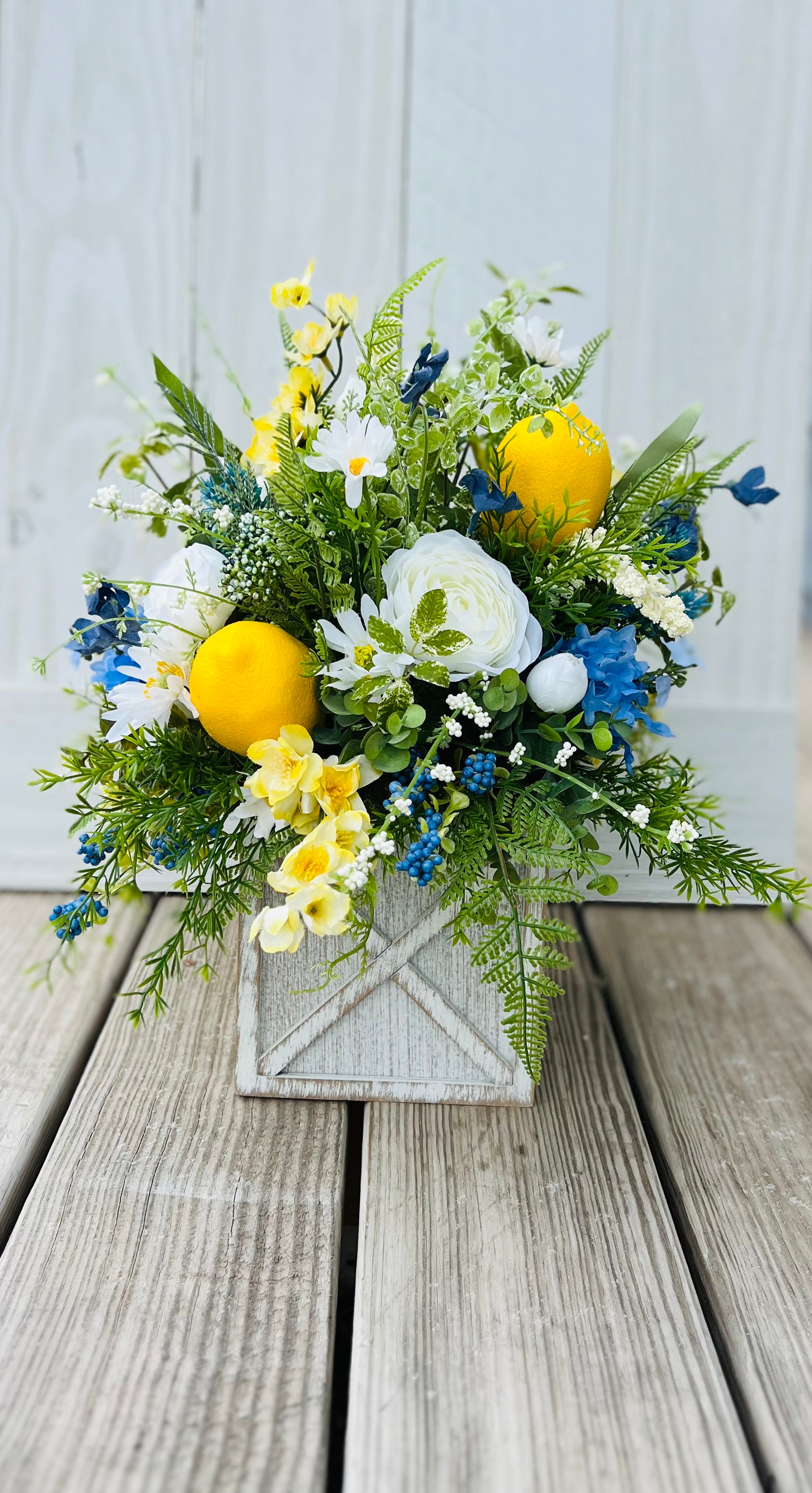 White ranunculus bundle styled in a lemon floral arrangement with mixed greenery and blue accents — Gardenbug Designs
