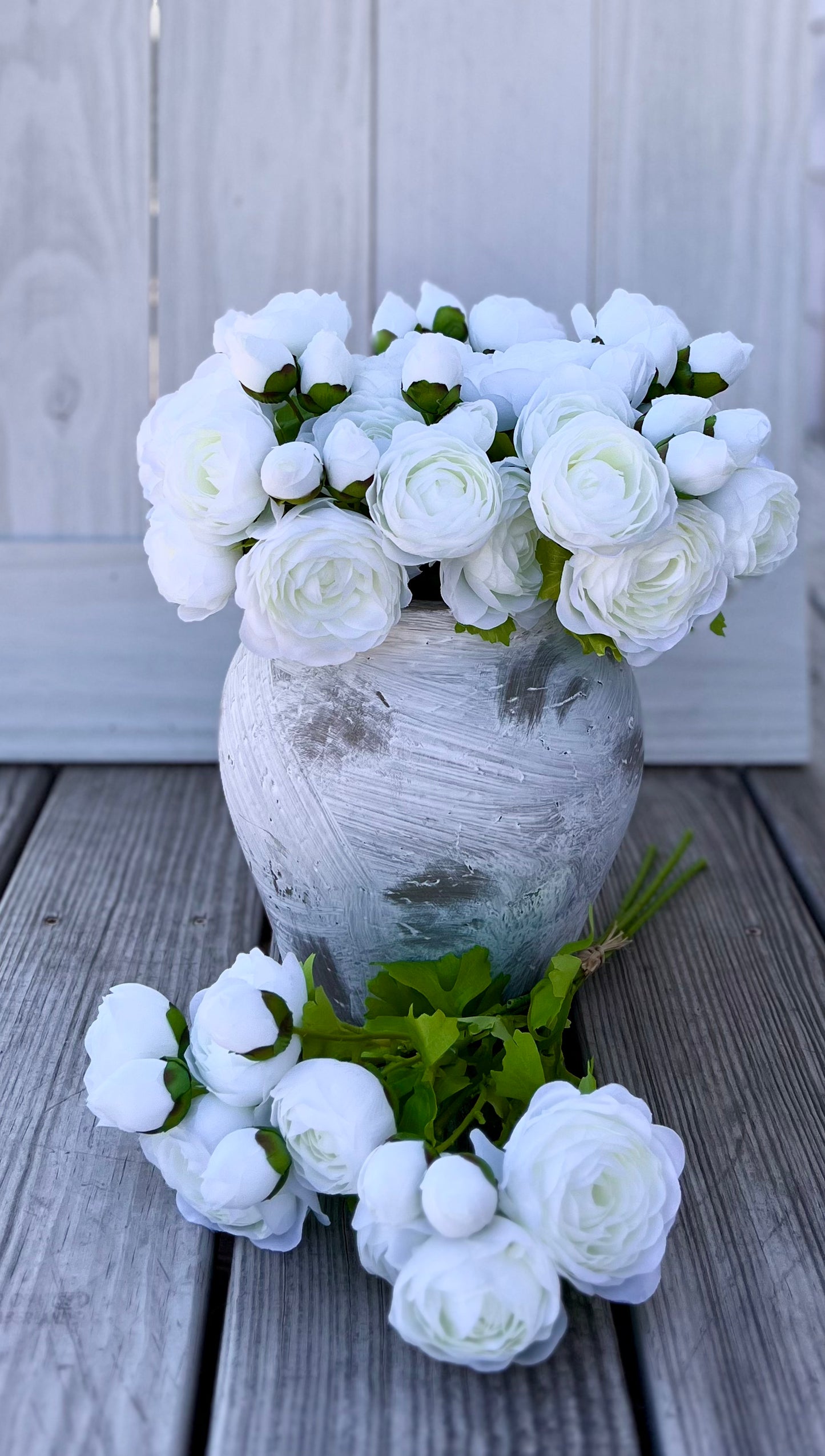 White ranunculus bundle styled in a vase with additional bundles shown, demonstrating fill, scale, and how multiple bundles arrange together