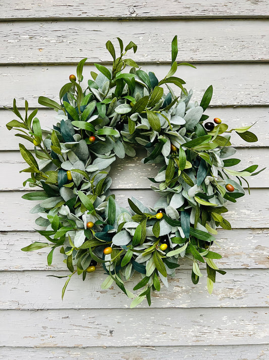 First Light olive wreath featuring realistic olive foliage and lamb's ear greenery styled on neutral exterior siding for everyday front door decor